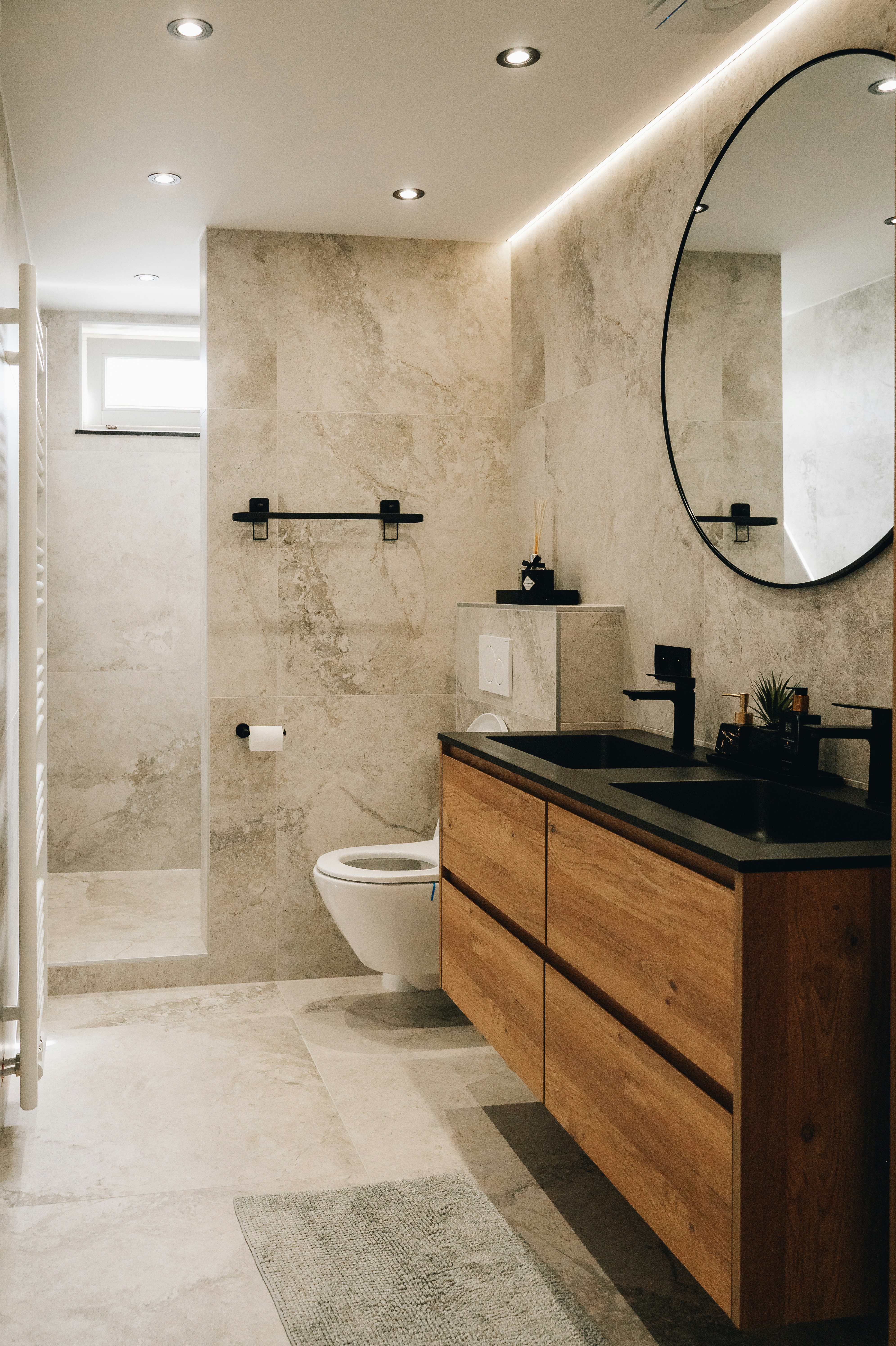 Premium bathroom with marble walls and wooden vanity