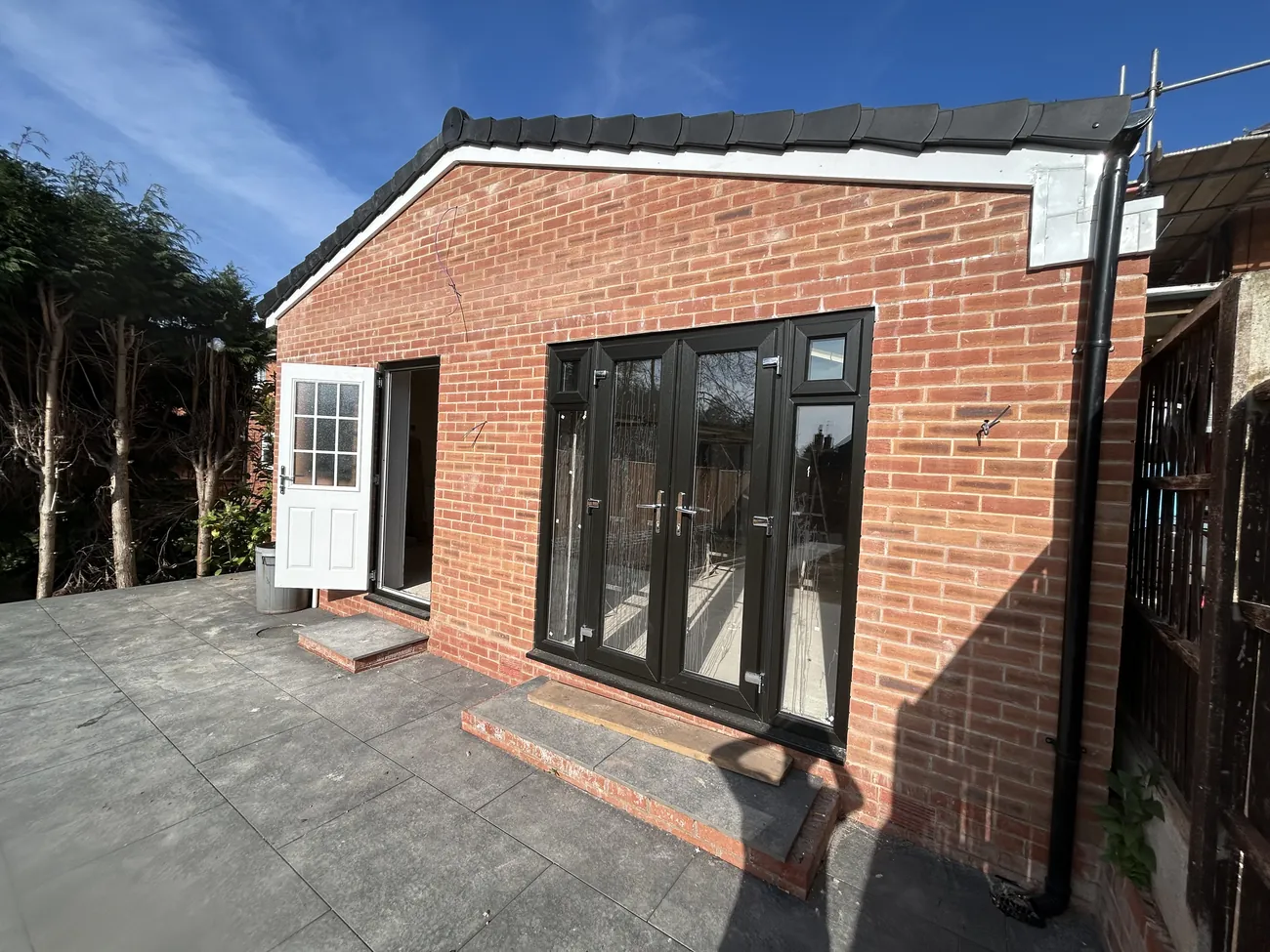 Completed brick rear extension with anthracite bifold doors