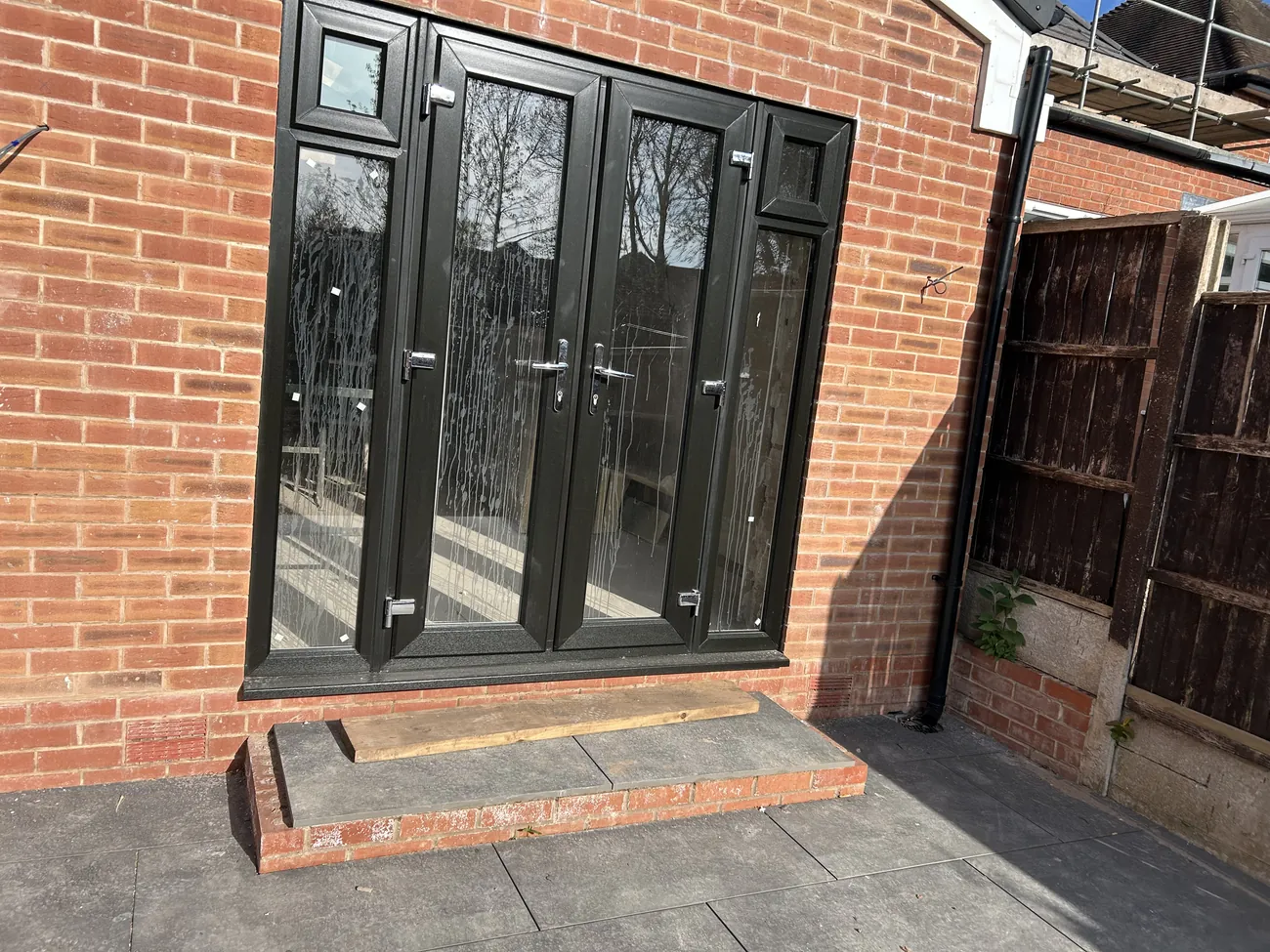 Anthracite bifold and French doors fitted to a brick extension