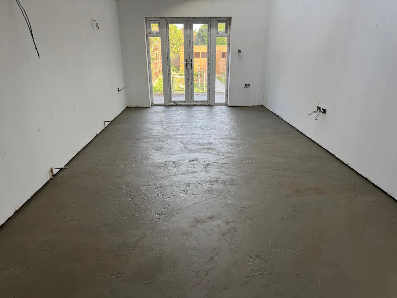 Newly plastered extension interior with French doors