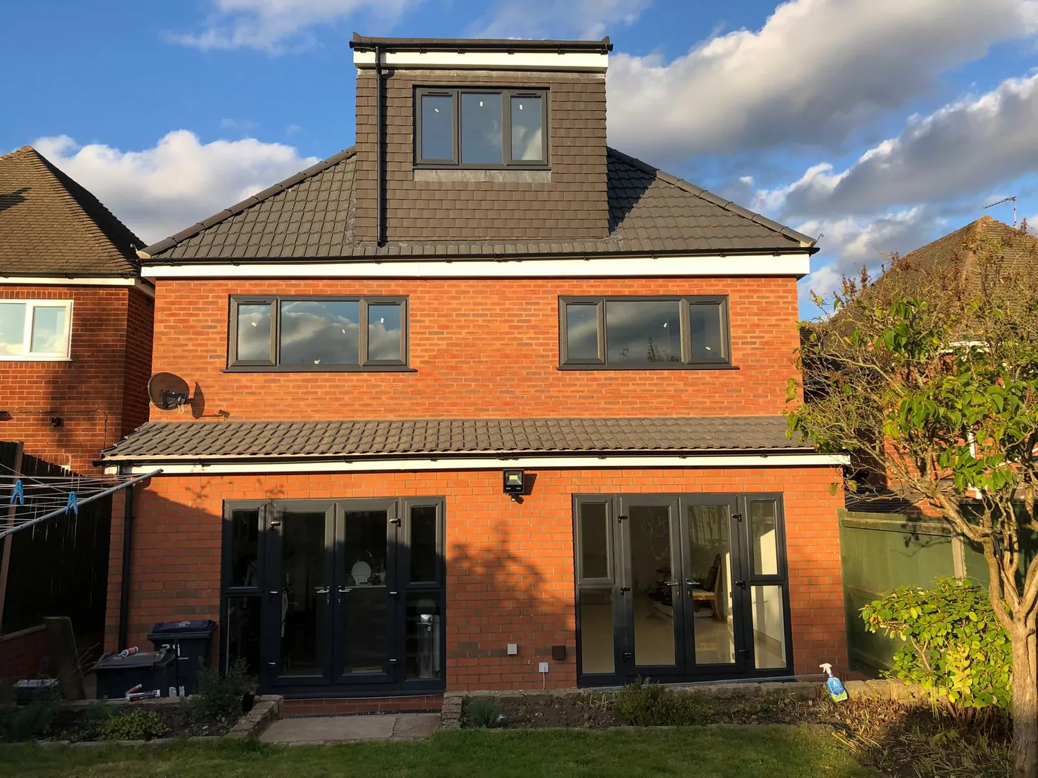 Completed rear house extension and dormer loft conversion in red brick, Birmingham
