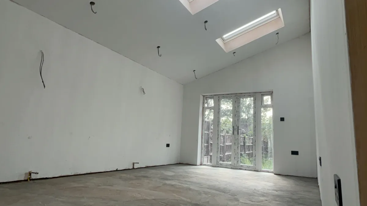 Open-plan extension interior with a vaulted ceiling and bifold doors