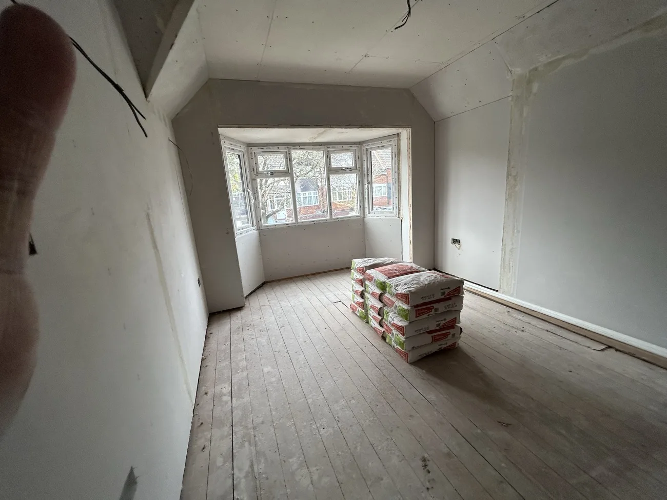 Renovated room with a bay window and new floorboards