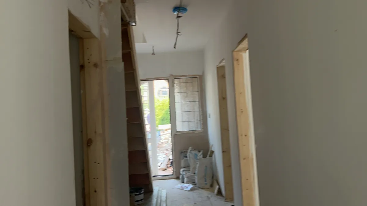 Timber door framing in a hallway during a renovation