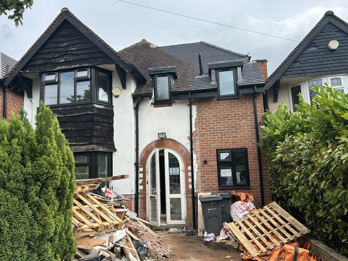 House exterior during a renovation with a new roof and dormer